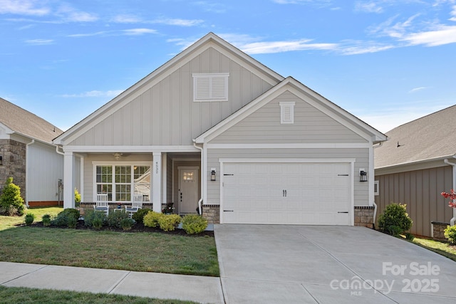 4532 Stellata Loop, Sherrills Ford, NC 28673 - view of front of property featuring covered porch, board and batten siding, stone siding, concrete driveway, and a front yard