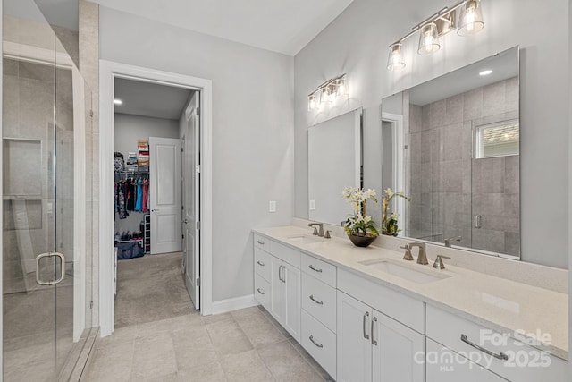 4532 Stellata Loop, Sherrills Ford, NC 28673 - full bathroom featuring a stall shower, double vanity, a walk in closet, and baseboards