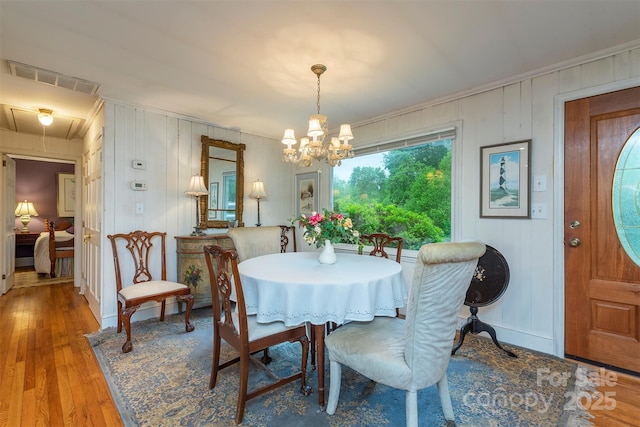 212 Vance Ave, Black Mountain, NC 28711 - dining room featuring a chandelier, ornamental molding, and wood-type flooring