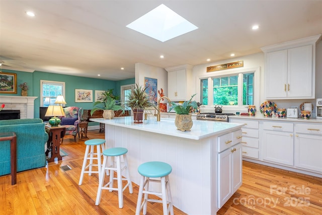 212 Vance Ave, Black Mountain, NC 28711 - kitchen featuring healthy amount of natural light, open floor plan, a breakfast bar, a skylight, and recessed lighting