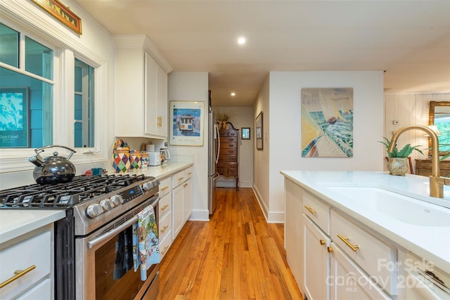 212 Vance Ave, Black Mountain, NC 28711 - kitchen with appliances with stainless steel finishes, a sink, white cabinetry, light countertops, and recessed lighting