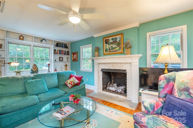 212 Vance Ave, Black Mountain, NC 28711 - living room with wood finished floors, a brick fireplace, ceiling fan, and crown molding