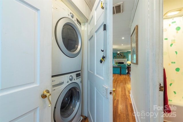 212 Vance Ave, Black Mountain, NC 28711 - laundry area with stacked washer / drying machine, light wood finished floors, recessed lighting, and a fireplace