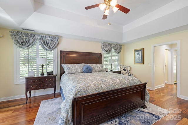 408 Emerald Bay Dr, Salisbury, NC 28146 - bedroom with a tray ceiling, wood finished floors, baseboards, and ceiling fan