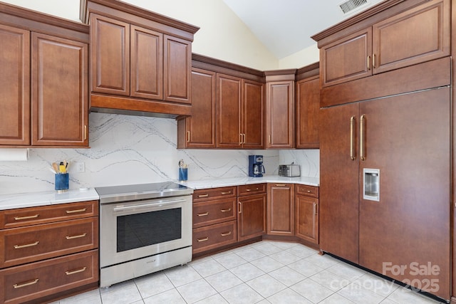 408 Emerald Bay Dr, Salisbury, NC 28146 - kitchen featuring stainless steel electric stove, lofted ceiling, light countertops, backsplash, and light tile patterned flooring