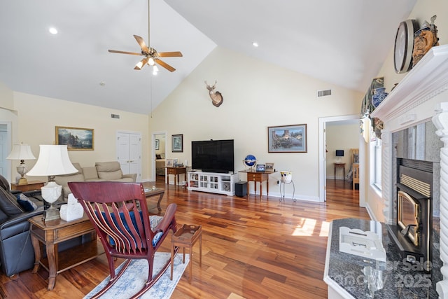 408 Emerald Bay Dr, Salisbury, NC 28146 - living area featuring high vaulted ceiling, ceiling fan, wood finished floors, a fireplace with raised hearth, and baseboards