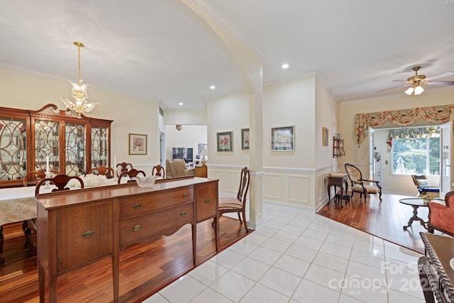 408 Emerald Bay Dr, Salisbury, NC 28146 - kitchen featuring a chandelier, light tile patterned floors, crown molding, a ceiling fan, and wainscoting