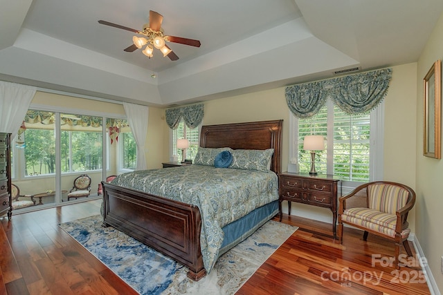 408 Emerald Bay Dr, Salisbury, NC 28146 - bedroom with a raised ceiling, multiple windows, wood finished floors, and a ceiling fan