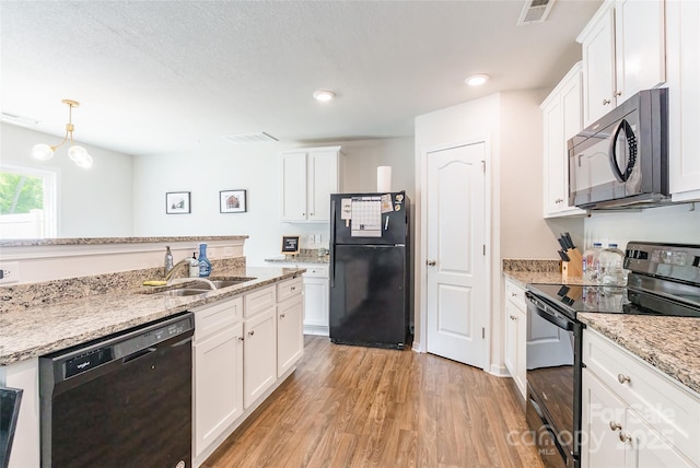 2009 Talbert Ct, Charlotte, NC 28214 - kitchen with black appliances, a sink, light wood-type flooring, white cabinetry, and recessed lighting