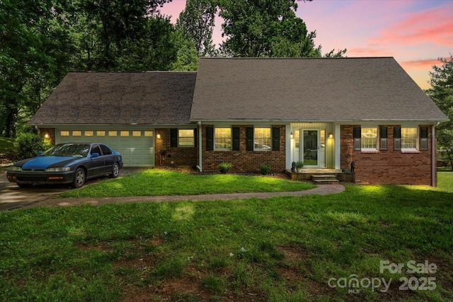 2701 Castes Dr, Pfafftown, NC 27040 - cape cod-style house featuring a garage, brick siding, a front yard, and driveway