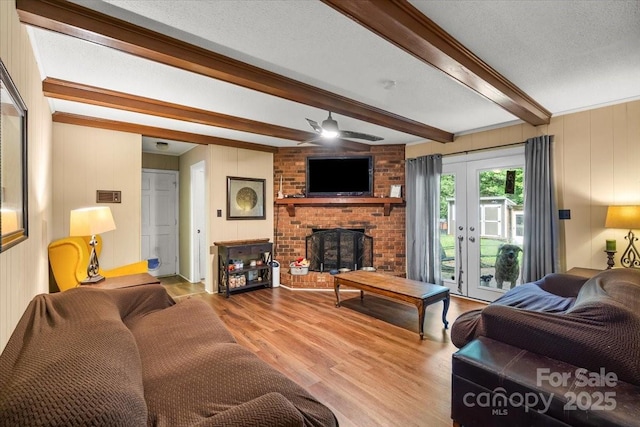 2701 Castes Dr, Pfafftown, NC 27040 - living area featuring beam ceiling, ceiling fan, wood finished floors, and a fireplace