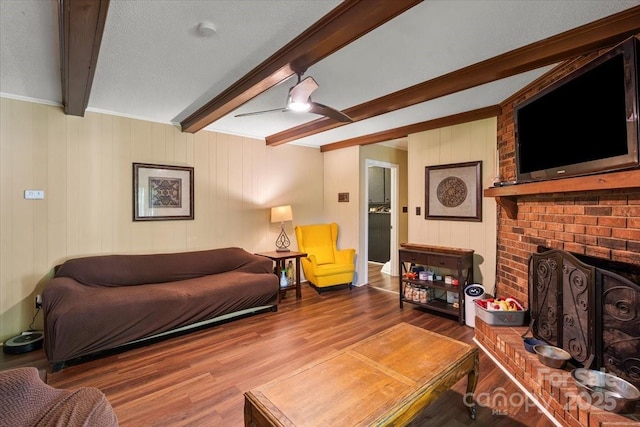 2701 Castes Dr, Pfafftown, NC 27040 - living area featuring beam ceiling, wood finished floors, and a fireplace