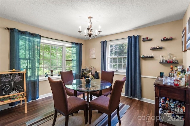 2701 Castes Dr, Pfafftown, NC 27040 - dining room featuring a chandelier, dark wood-type flooring, baseboards, and a textured ceiling