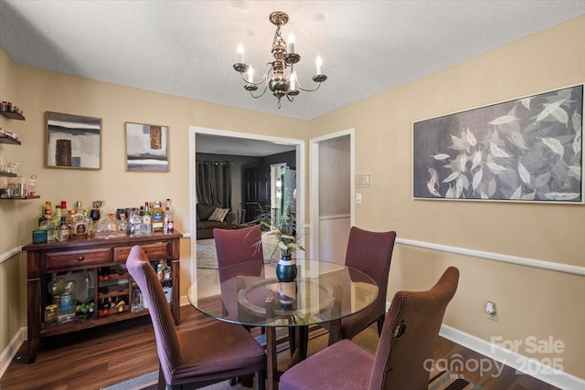 2701 Castes Dr, Pfafftown, NC 27040 - dining space featuring a chandelier, wood finished floors, and baseboards