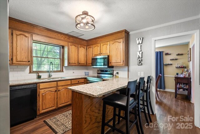 2701 Castes Dr, Pfafftown, NC 27040 - kitchen featuring appliances with stainless steel finishes, a sink, dark wood-type flooring, backsplash, and a peninsula