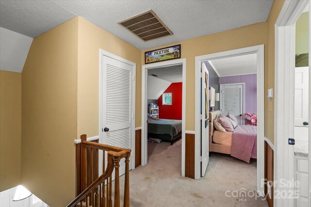 2701 Castes Dr, Pfafftown, NC 27040 - hall featuring light carpet, a textured ceiling, and an upstairs landing