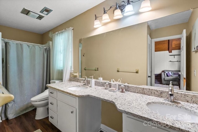 2701 Castes Dr, Pfafftown, NC 27040 - full bathroom with toilet, wood finished floors, double vanity, and a shower with curtain