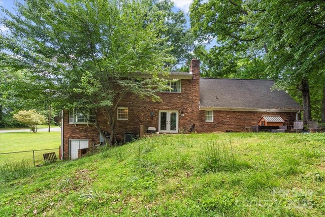 2701 Castes Dr, Pfafftown, NC 27040 - rear view of house featuring french doors, brick siding, and a chimney