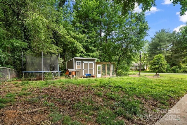 2701 Castes Dr, Pfafftown, NC 27040 - view of yard with a storage shed, an outdoor structure, a trampoline, and fence