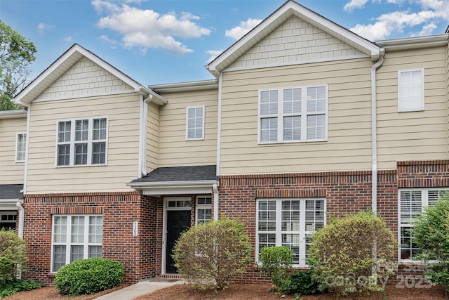townhome / multi-family property with brick siding