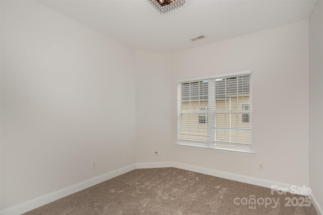 carpeted spare room with baseboards