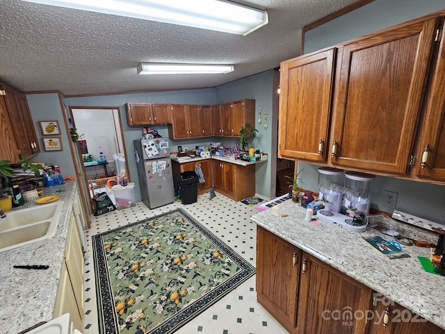 616/620 Pole Miller Ext, Brevard, NC 28712 - kitchen featuring light flooring, a sink, a textured ceiling, brown cabinets, and freestanding refrigerator