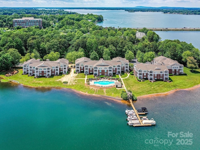 bird's eye view of a nearby body of water and a pool area