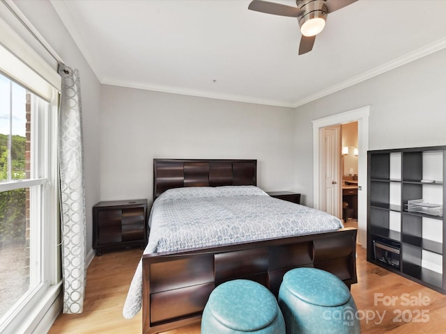 bedroom featuring light wood-style flooring, crown molding, and a ceiling fan