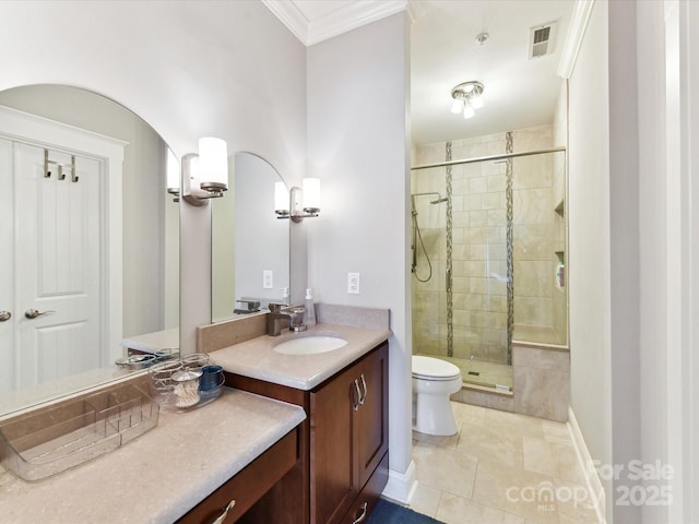 bathroom with a shower stall, vanity, crown molding, tile patterned flooring, and toilet