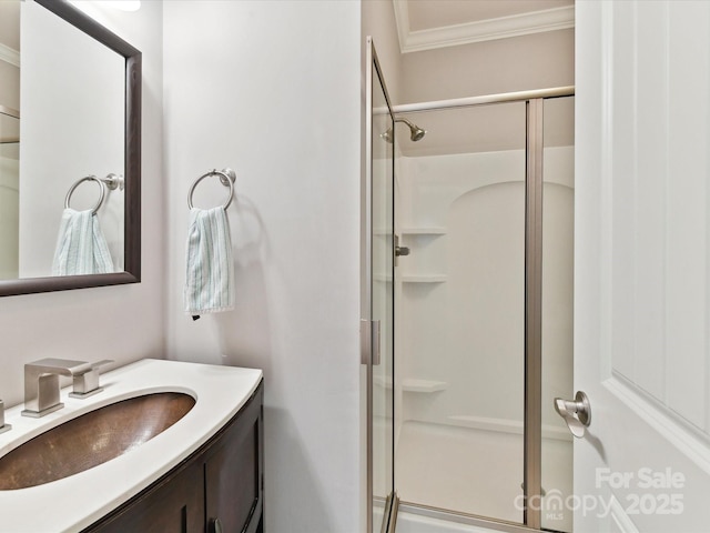 bathroom featuring a shower stall, crown molding, and vanity
