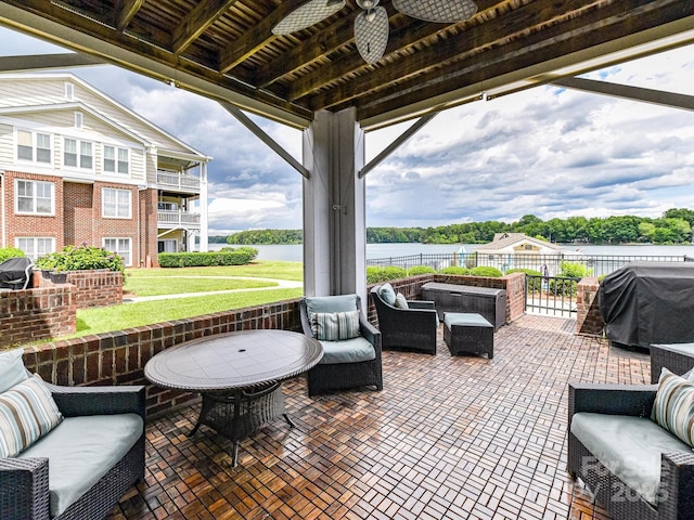 view of patio featuring grilling area, a water view, and an outdoor hangout area