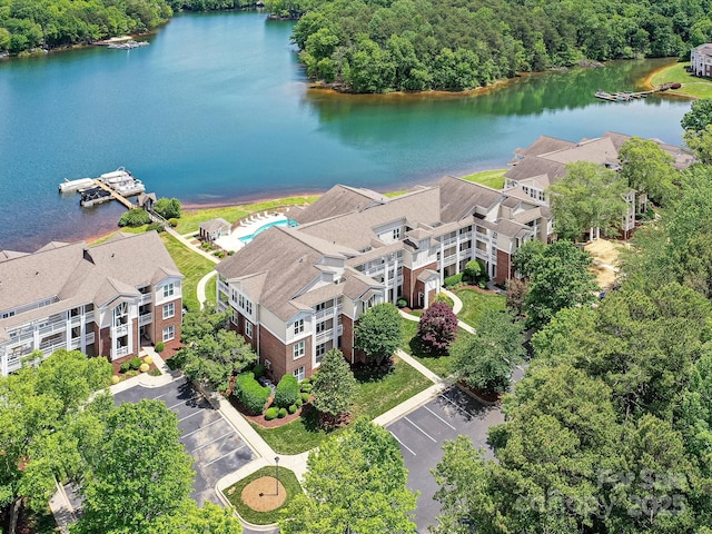 drone / aerial view of a large body of water and a forest