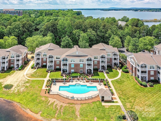 bird's eye view of a nearby body of water and a pool area