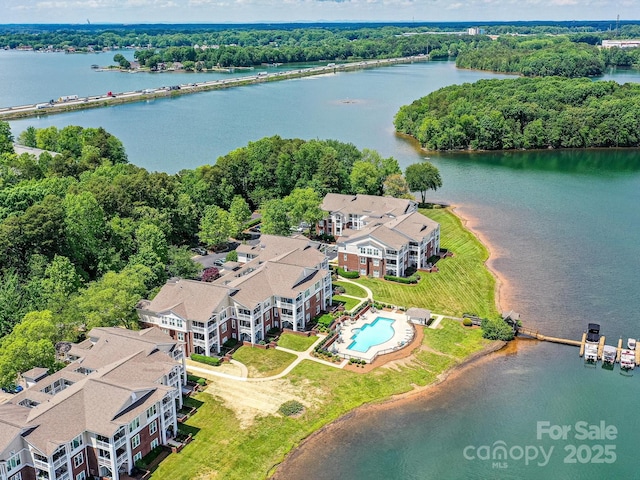 bird's eye view of a pool area and a nearby body of water