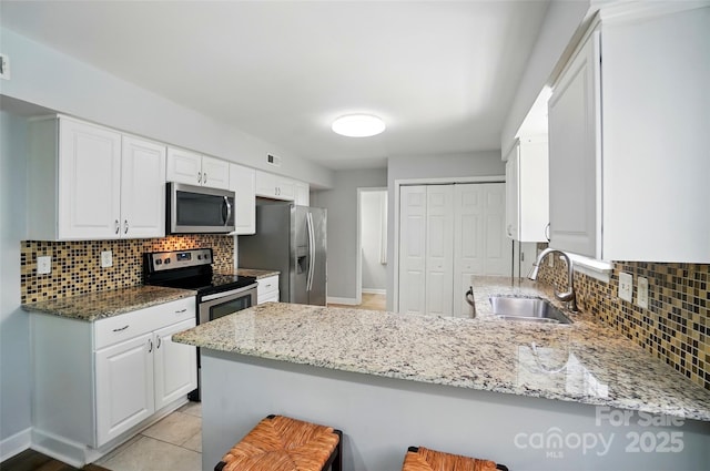 8014 Sherington Way, Charlotte, NC 28227 - kitchen featuring stainless steel appliances, a sink, a peninsula, and tasteful backsplash