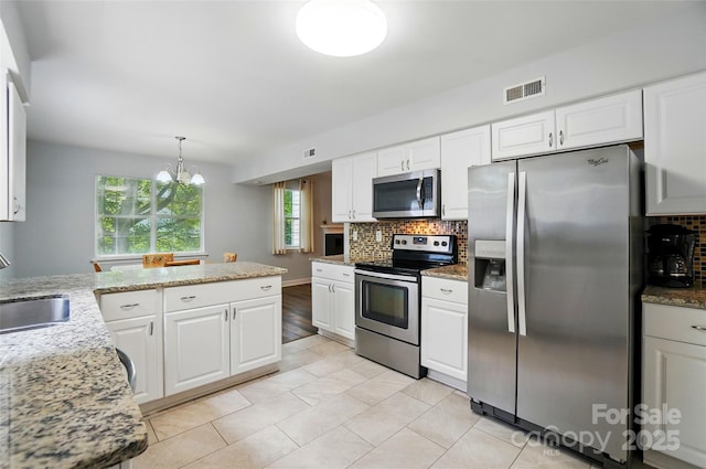 8014 Sherington Way, Charlotte, NC 28227 - kitchen with stainless steel appliances, backsplash, and white cabinetry