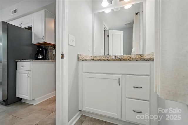 8014 Sherington Way, Charlotte, NC 28227 - bathroom featuring backsplash, vanity, tile patterned flooring, and baseboards