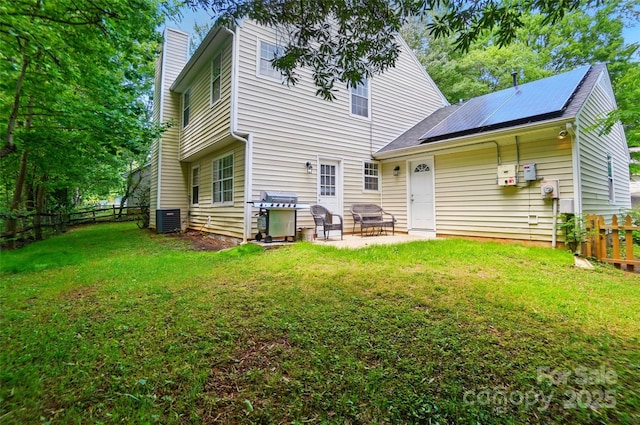 8014 Sherington Way, Charlotte, NC 28227 - rear view of property with a patio, a chimney, roof mounted solar panels, and central AC