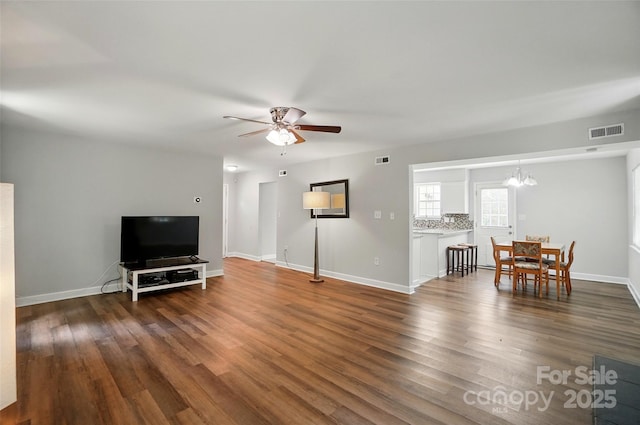 8014 Sherington Way, Charlotte, NC 28227 - living room with ceiling fan, dark wood-type flooring, a chandelier, and baseboards