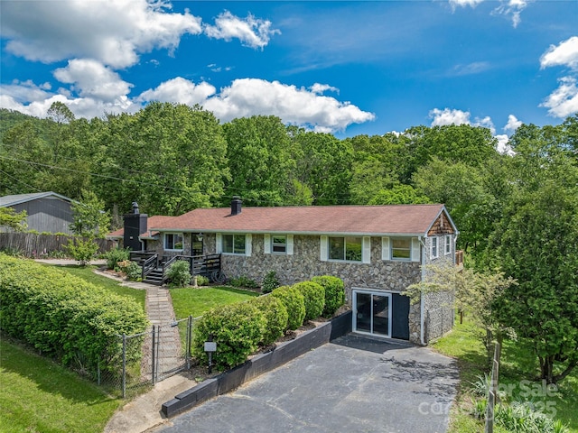 143 Mountain Crest Rd, Swannanoa, NC 28778 - view of front of home with stone siding, a gate, driveway, and a view of trees