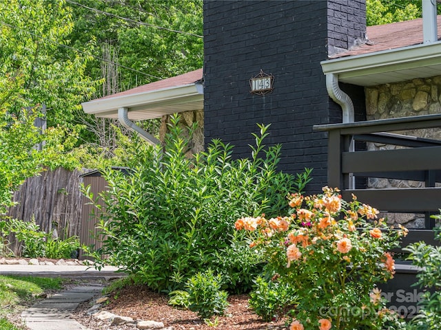 143 Mountain Crest Rd, Swannanoa, NC 28778 - view of home's exterior with fence, a chimney, and stone siding