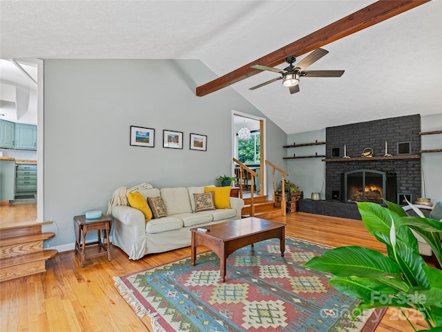 143 Mountain Crest Rd, Swannanoa, NC 28778 - living room featuring stairs, ceiling fan, light wood finished floors, a brick fireplace, and baseboards