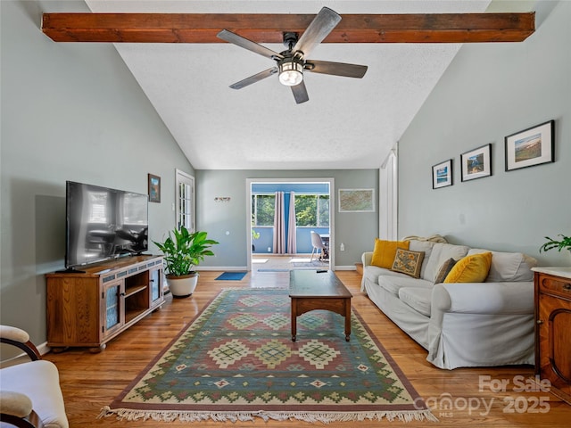 143 Mountain Crest Rd, Swannanoa, NC 28778 - living room featuring wood finished floors, beamed ceiling, a ceiling fan, baseboards, and a textured ceiling
