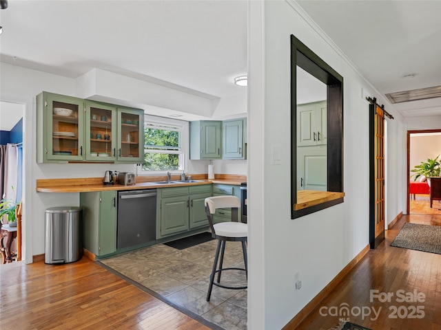 143 Mountain Crest Rd, Swannanoa, NC 28778 - kitchen with green cabinetry, stainless steel dishwasher, a sink, butcher block counters, and dark wood-type flooring