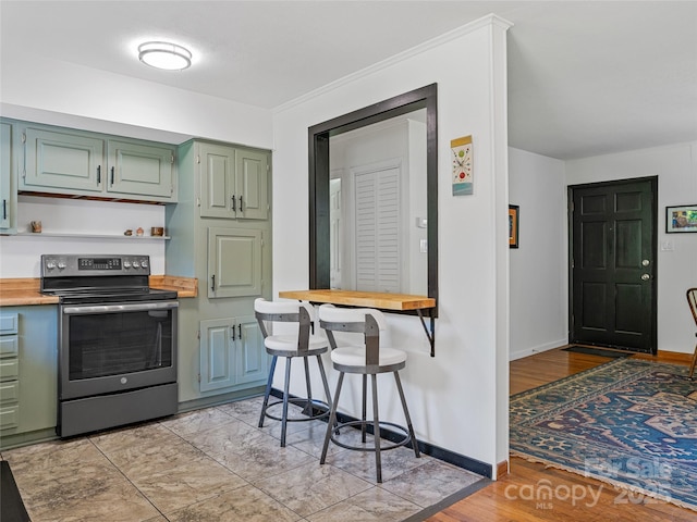 143 Mountain Crest Rd, Swannanoa, NC 28778 - kitchen featuring stainless steel electric range, green cabinetry, baseboards, wooden counters, and light wood-type flooring