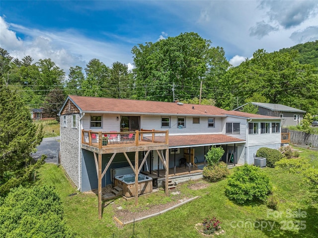 143 Mountain Crest Rd, Swannanoa, NC 28778 - rear view of house with a deck, central AC, and a lawn