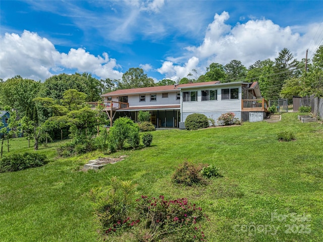 143 Mountain Crest Rd, Swannanoa, NC 28778 - rear view of property with a yard, a sunroom, and a deck