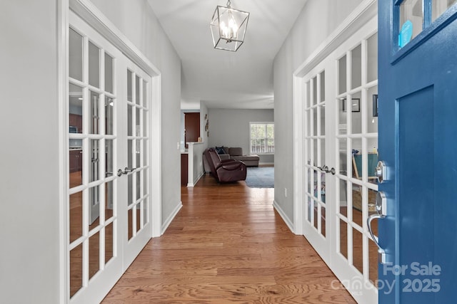 1230 Long Creek Ln, Salisbury, NC 28146 - entrance foyer with french doors, wood finished floors, a chandelier, and baseboards