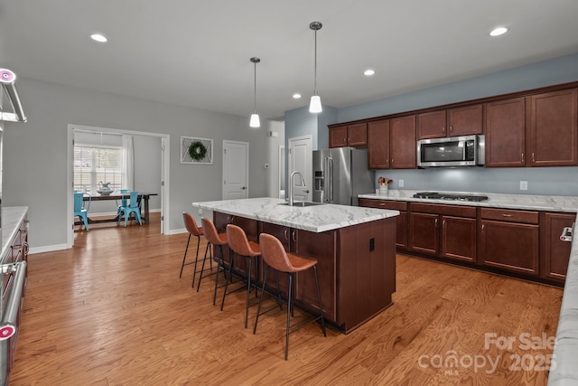 1230 Long Creek Ln, Salisbury, NC 28146 - kitchen with appliances with stainless steel finishes, a sink, light wood-style floors, a kitchen breakfast bar, and recessed lighting