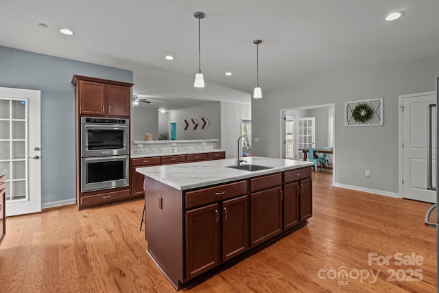 1230 Long Creek Ln, Salisbury, NC 28146 - kitchen with a sink, double oven, light wood finished floors, baseboards, and recessed lighting